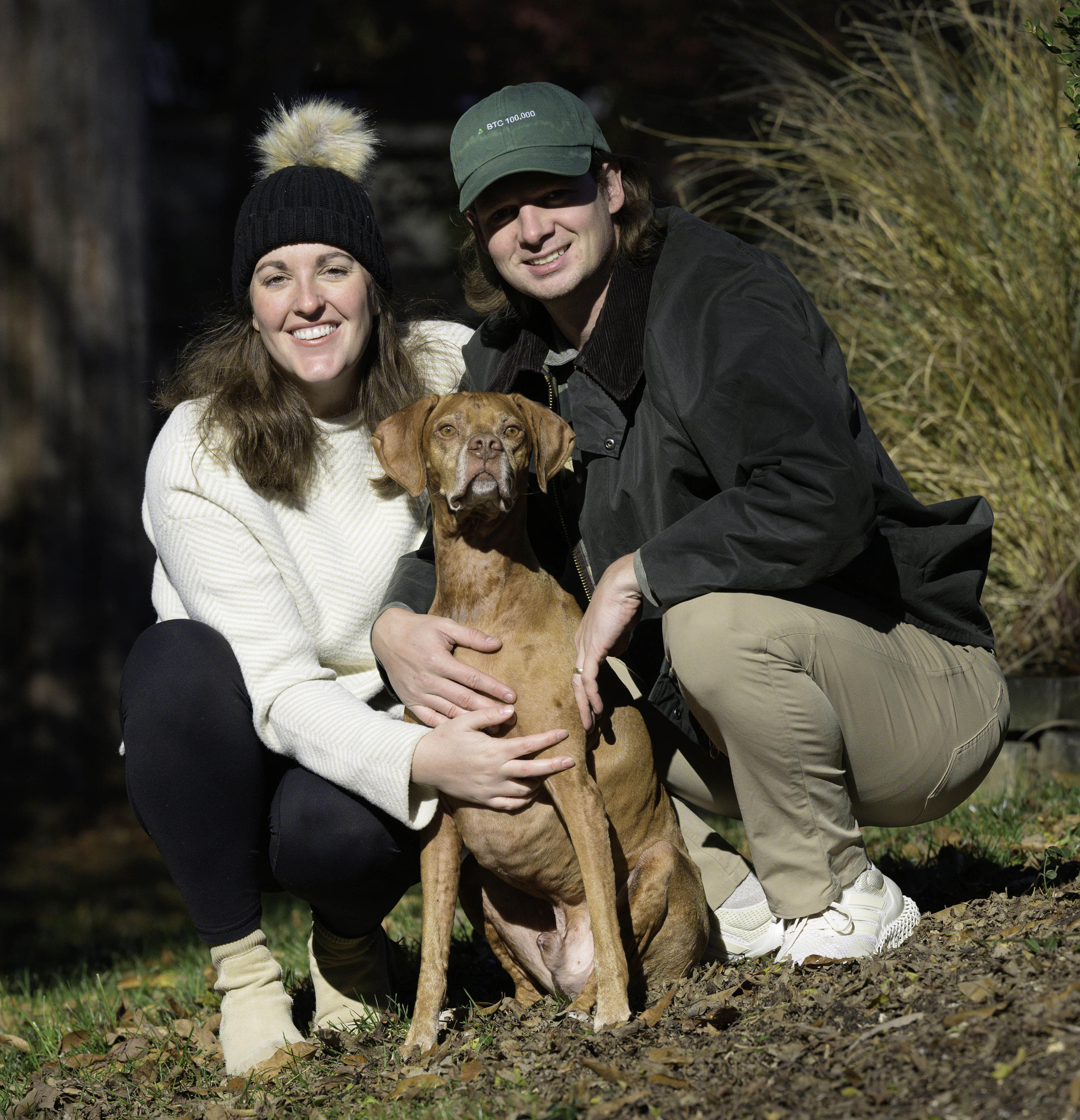 Ralph is one happy dude getting to pose with his human mom and dad after a morning romp in the fall sun.